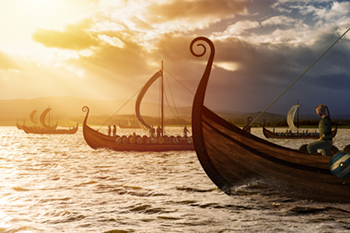 A flotilla of Viking longships under sail with striped square rigs